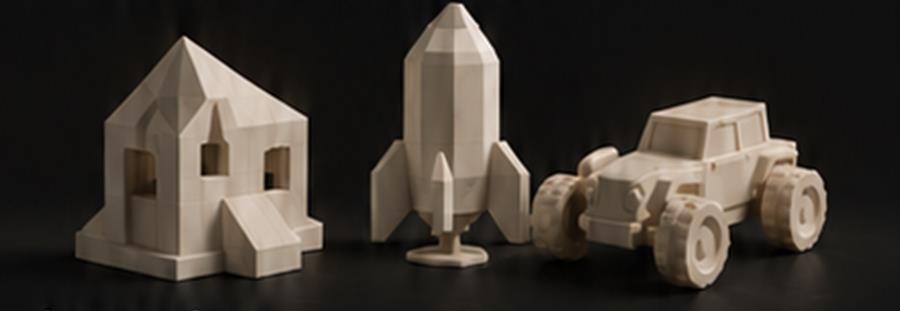 Konzeptbild: gedruckte Modelle eines Hauses, einer Rakete und eines Geländewagens